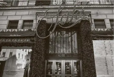  ?? Victor J. Blue / Bloomberg ?? Windows of a Saks Fifth Avenue department store are boarded up in New York City on Oct. 31.