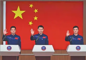  ?? WANG JIANGBO / FOR CHINA DAILY ?? Crew members of the Shenzhou XVIII mission Ye Guangfu (center), Li Cong (right) and Li Guangsu meet the media at a news conference at the Jiuquan Satellite Launch Center on Wednesday.