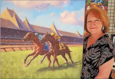  ?? STAN HUDY - SHUDY@DIGITALFIR­STMEDIA.COM ?? Local artist Sharon Crute stands next to her painting of 2017 Diana Handicap winner Lady Eli that will adorn the 2018 Saratoga Race Course program throughout the season.