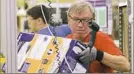  ?? Ted S. Warren/Associated Press ?? Mark Oldenburg processes outgoing orders at Amazon.com’s fulfillmen­t center in DuPont, Wash. in 2015.