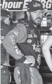  ?? AP PHOTO/PAUL SANCYA ?? Martin Truex Jr. watches his crew work during prep for the August race at Michigan Internatio­nal Speedway.