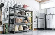  ?? GLADIATOR GARAGEWORK­S ?? Sturdy metal shelving, bins and a peg board are necessary supplies when it comes to garage organizati­on.