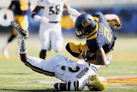  ?? Thearon W. Henderson / Getty Images ?? Cal’s Daniel Lasco, who ran for a team-high 44 yards and two TDs, is upended by UCLA’s Jaleel Wadood in the second quarter.