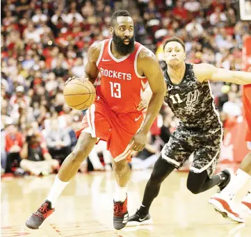  ?? — AFP photo ?? James Harden (L) of the Houston Rockets drives past Bryn Forbes of the San Antonio Spurs at Toyota Center on March 12, 2018 in Houston,Texas.