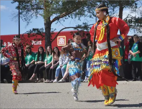  ?? Photos by Matthew Liebenberg/Prairie Post ?? Pow wow dancers from Nekaneet First Nation perform the jingle dress dance during the ReconciliA­CTION outdoor program on Market Square, May 11. The lead dancer is Whitney Oakes. She is followed by Skyla Stanley (6) and Karissa Stanley (9).