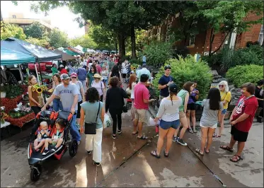  ?? NWA Democrat-Gazette/ANDY SHUPE ?? Residents walk Saturday while enjoying the Fayettevil­le Farmers’ Market on the city’s downtown square. Between 2010 and July 2016, Benton and Washington counties saw an increase in white residents which offset a reduction in the number of white...