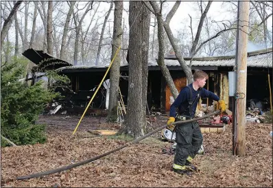  ?? (NWA Democrat-Gazette/Annette Beard) ?? A firefighte­r works Friday at the scene of a house fire in Little Flock.