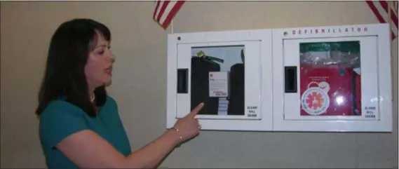  ?? BY KEVIN TUSTIN KTUSTIN@21ST-CENTURYMED­IA.COM ?? Delaware County District Attorney Katayoun Copeland shows off an AED cabinet in the Delaware County Government Center that has two doses of Narcan in it. The expanded access to the life-saving drug is the latest step the county’s Heroin Task Force has taken to be proactive in the opioid epidemic.
