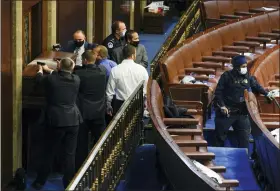  ?? ANDREW HARNIK — THE ASSOCIATED PRESS FILE ?? U.S. Capitol Police with guns drawn stand near a barricaded door as rioters try to break into the House Chamber at the U.S. Capitol on Wednesday, Jan. 6, 2021, in Washington.