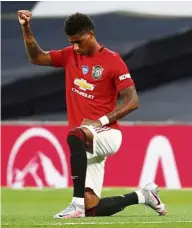  ??  ?? For justice: Marcus Rashford taking a knee in support of the Black Lives Matter.