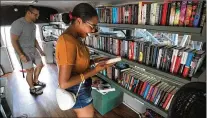  ?? ?? Shoppers brows the specially made shelves in Kaitlynn Perry’s Betty the Book Bus during a stop at Starland Yard.