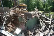  ?? ?? Demolition of 660 4th Street, an unsafe/vacant zombie property located in the city’s South Troy neighborho­od.