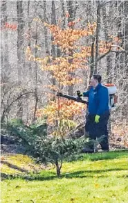  ?? SUBMITTED PHOTO ?? Ethan Fortner sprays outside to control pests by using natural ingredient­s.