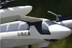  ?? – AFP photo ?? A model of Uber’s electric vertical take-off and landing vehicle concept (eVTOL) flying taxi is displayed at the second annual Uber Elevate Summit in Los Angeles, California.