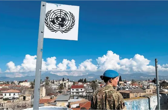  ?? afp ?? Corporal anna rowell from the British army’s 71 engineer regiment, a member of unficyp, keeping watch from a rooftop of an abandoned building while patrolling along the buffer zone, which separates the internatio­nally recognised republic of Cyprus and the breakaway Turkyish republic of Northern Cyprus, recognised only by ankara in the divided capital Nicosia. —