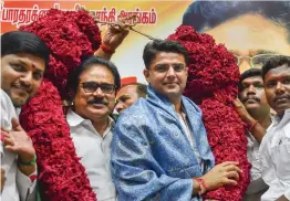  ?? — PTI ?? Rajasthan Congress president Sachin Pilot and Tamil Nadu Congress Committee ( TNCC) Thirunavuk­karasar being garlanded by party workers during a press conference, in Chennai on Monday