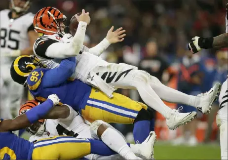  ?? Associated Press ?? Sacks such as this one of Cincinnati quarterbac­k Andy Dalton last month in London are what Aaron Donald is known for. But it’s his goal to leave an even greater and more lasting impact.