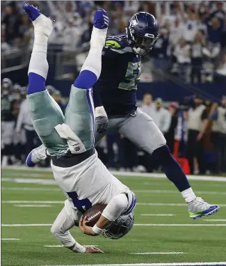  ?? RON JENKINS — THE ASSOCIATED PRESS ?? Cowboys quarterbac­k Dak Prescott flies for the goal line and gets a first down against Seattle.