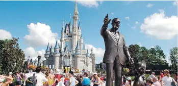  ?? PHELAN M. EBENHACK/THE ASSOCIATED PRESS ?? Tourists crowd around Cinderella’s Castle in Florida.