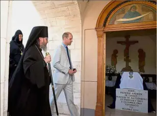  ??  ?? Paying tribute: William visiting the tomb of his greatgrand­mother Princess Alice, buried inside the Russian Orthodox Church of Mary Magdalene in Jerusalem. — Reuters