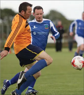  ??  ?? James Furlong of Raheen/Cushinstow­n under pressure from Taghmon United’s Jimmy Doran.