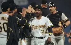  ?? John Swart/Associated Press ?? Barry Bonds high-fives teammates after the Pirates' 13-4 win over the Atlanta Braves in Game 6 of the 1992 NLCS.