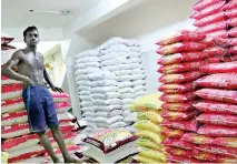  ??  ?? Stocks of imported rice in a warehouse