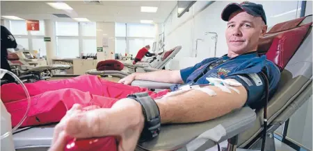  ?? Photo: Lawrence Smith/Fairfax Media ?? LIfesaver: Westpac helicopter pilot Paul Robinson gives his 100th donation.