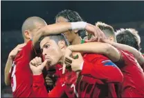  ?? FELIX ORDONEZ/ REUTERS ?? Portugal’s Cristiano Ronaldo ( front) celebrates with teammates after scoring one of his two goal against Netherland­s Sunday.