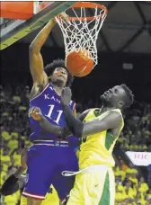  ?? KEVIN JAIRAJ/USA TODAY ?? Kansas guard Josh Jackson dunks over Baylor forward Jo Lual-Acuil Jr. in the second half of the No. 3-ranked Jayhawks’ 67-65 win over the No. 4 Bears on Saturday. Jackson scored 16 points.