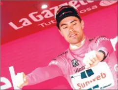  ?? AFP ?? Tom Dumoulin inspects the pink jersey on the podium after the 17th stage of the 100th Giro d’Italia on Wednesday.