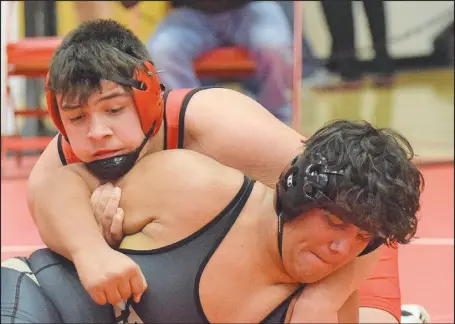  ??  ?? McDonald County’s Jayce Hitt tries to get Neosho’s Nicolas olivares to his back in a 285-pound match in the district semifinals. hitt eventually pinned olivares on the way to a district title.