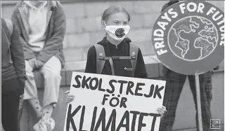  ?? STOCKHOLM
-REUTERS ?? Swedish climate activist Greta Thunberg holds a poster reading "School strike for Climate" as she protests in front of the Swedish Parliament Riksdagen in Sweden.