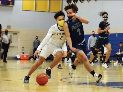  ?? OWEN MCCUE — MEDIANEWS GROUP ?? Upper Merion’s Lukas Kim, left, attempts to drive past Pottstown’s Joneil Oister on Friday night.