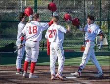  ?? AMANDA SABGA / BOSTON HERALD ?? GOING DEEP: Catholic Memorial teammates congratula­te Nick DiRito as he arrives at the plate after a three-run home run against BC High on Monday.