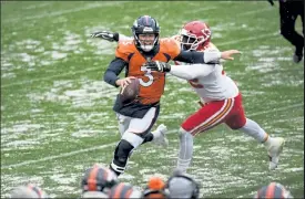  ?? Helen H. Richardson / The Denver Post ?? With 18 seconds left on the clock in the second quarter Denver Broncos quarterbac­k Drew Lock tries to pass the ball before getting taken down by Kansas City Chiefs' defensive end Tanoh Kpassagnon at Empower Field at Mile High Sunday.