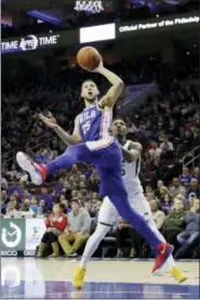  ?? MATT SLOCUM — THE ASSOCIATED PRESS FILE ?? In this file photo, Philadelph­ia 76ers’ Ben Simmons, left, goes up for a shot against Utah Jazz’s Donovan Mitchell, right.