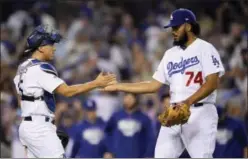  ?? MARK J. TERRILL — THE ASSOCIATED PRESS ?? Dodgers relief pitcher Kenley Jansen, right, celebrates the team’s 5-2 win with catcher Austin Barnes over Cubs in Game 1 of National League Championsh­ip Series.