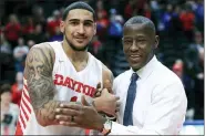  ?? AARON DOSTER — THE ASSOCIATED PRESS FILE ?? In this Feb. 22, 2020, file photo, Dayton’s Obi Toppin, left, celebrates scoring his 1,000th career point with head coach Anthony Grant after an NCAA college basketball game against Duquesne, in Dayton, Ohio. Toppin and Grant have claimed top honors from The Associated Press after leading the Flyers to a No. 3 final ranking. Toppin was voted the AP men’s college basketball player of the year, Tuesday, March 24, 2020. Grant is the AP coach of the year.