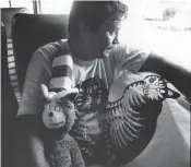  ?? STAFF FILE ?? Virginian-Pilot columnist Larry Maddry is shown in 1981 on a bus en route to California to cover a meowing contest featuring local hero Fred the Cat.