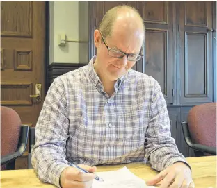  ?? DAVE STEWART/THE GUARDIAN ?? Richard MacEwen, manager of Charlottet­own’s Water and Sewer Utility Corp., looks over a motion that would see CBCL Ltd. handle the engineerin­g work associated with bringing in a new clarifier at the city’s treatment plant on Riverside Drive. The new clarifier will help the plant handle extra flow coming in from East Royalty and soon from the town of Stratford.