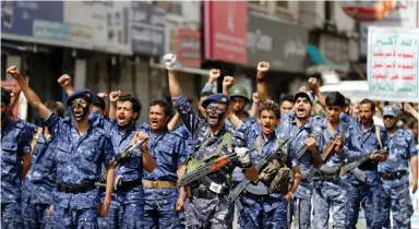  ??  ?? MEMBERS OF a security force loyal to the Houthi rebels take part in a military parade at Tahrir Square in downtown Sanaa yesterday. The placard reads: ‘Allah is the greatest. Death to America, death to Israel, a curse on the Jews, victory to Islam.’