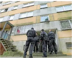  ?? FOTO:WÜSTNECK/DPA ?? Polizisten nehmen im Plattenbau­viertel bei Schwerin einen Islamisten aus Syrien fest. Es wurden zeitgleich drei Wohnungen durchsucht.