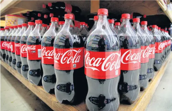  ?? Scott Olson ?? > Coca-Cola is planning to double the amount of recycled material in its plastic bottles used in the UK