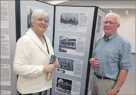  ?? SUEANN MUSICK/THE NEWS ?? Michal Crowe, left, chair of Canada 150 project for Heritage Trust of Nova Scotia, stands with Trenton resident Fergie MacKay near a pictorial exhibit hat includes photos of pre-Confederat­ion buildings in Pictou County. The Witness to a New Nation is a...