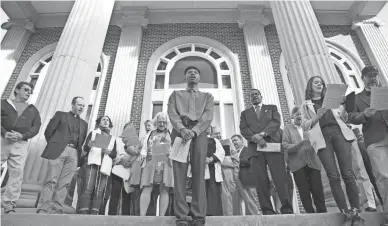  ?? SEAN RAYFORD/GETTY IMAGES FILE ?? Religious leaders sing at the courthouse in Brunswick, Ga., as jury selection began Oct. 18 in the trial of the defendants in the shooting death of Ahmaud Arbery.