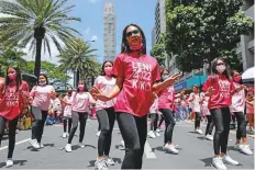  ?? Reuters ?? Supporters of Vice President and presidenti­al candidate Leni Robredo dance during a rally in Makati, Metro Manila, yesterday.