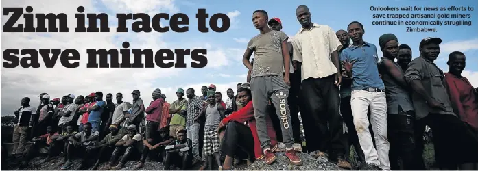  ??  ?? Onlookers wait for news as efforts to save trapped artisanal gold miners continue in economical­ly struglling Zimbabwe.