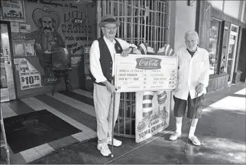  ?? FILE PHOTO ?? BOB (LEFT) AND BILL LUTES HOLD A 1950S MENU in front of Lutes Casino in this 2016 photo.