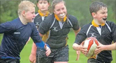  ??  ?? Mid Argyll’s Murray Macdonald on the ball, supported by Aileen Barr and James Campbell, as Kintyre player Ruaraidh Campbell applies pressure in a P6/7 match.